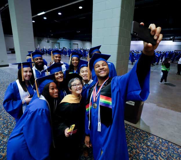 a group of graduates pose for a selfie