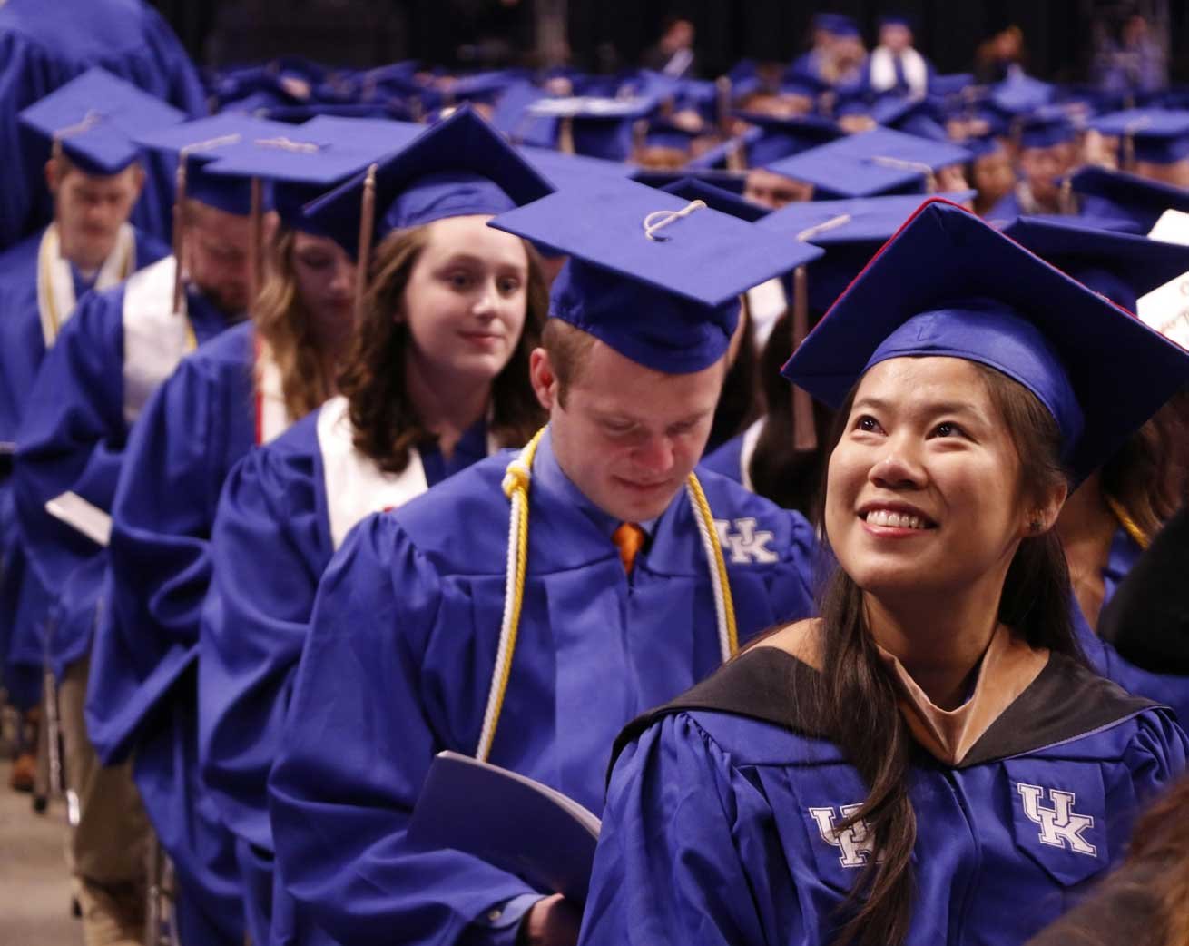 smiling female student in graduation robes
