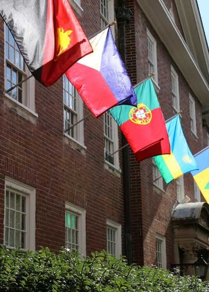 flags of many countries adorn the side of a building