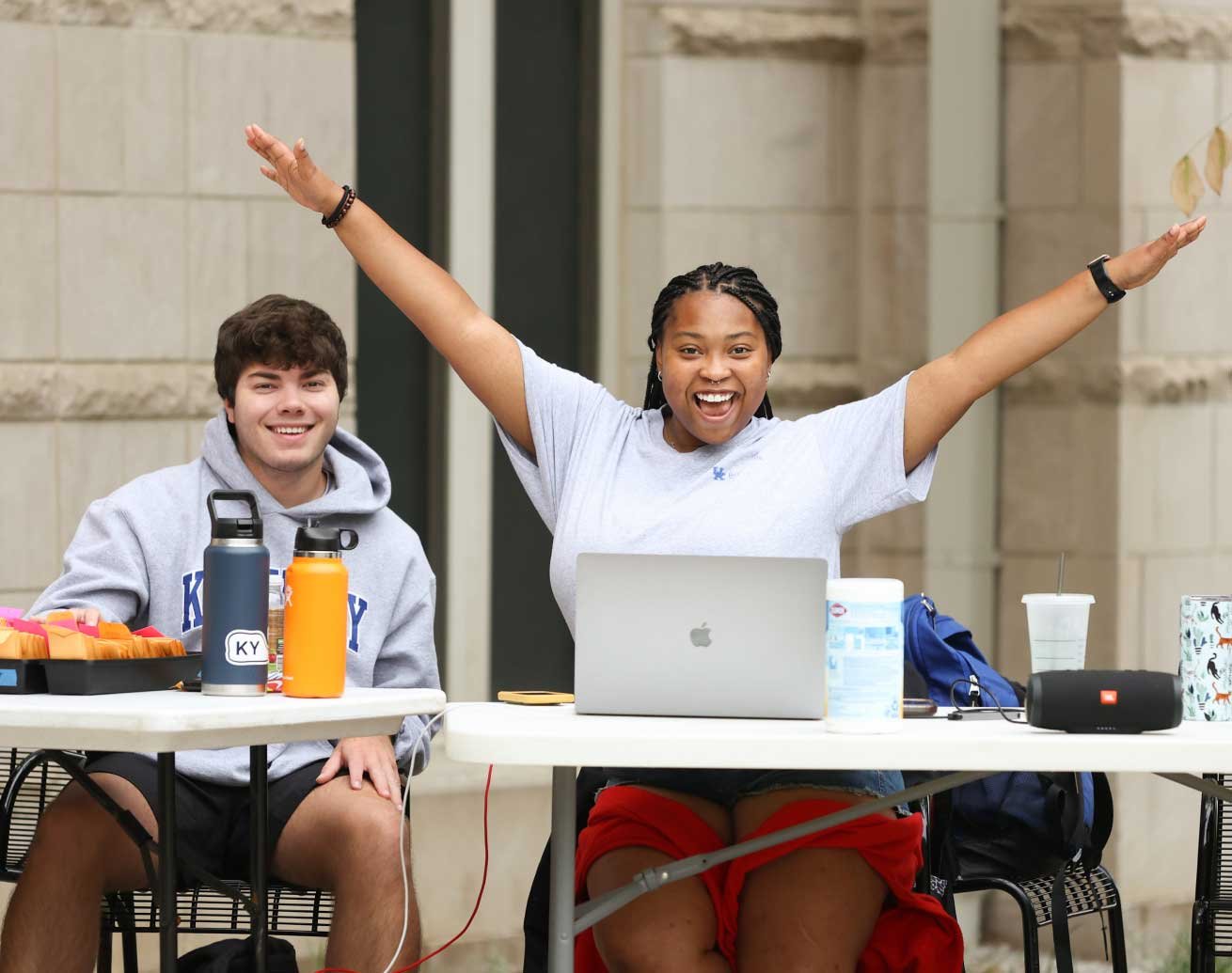 happy students at an outdoor table
